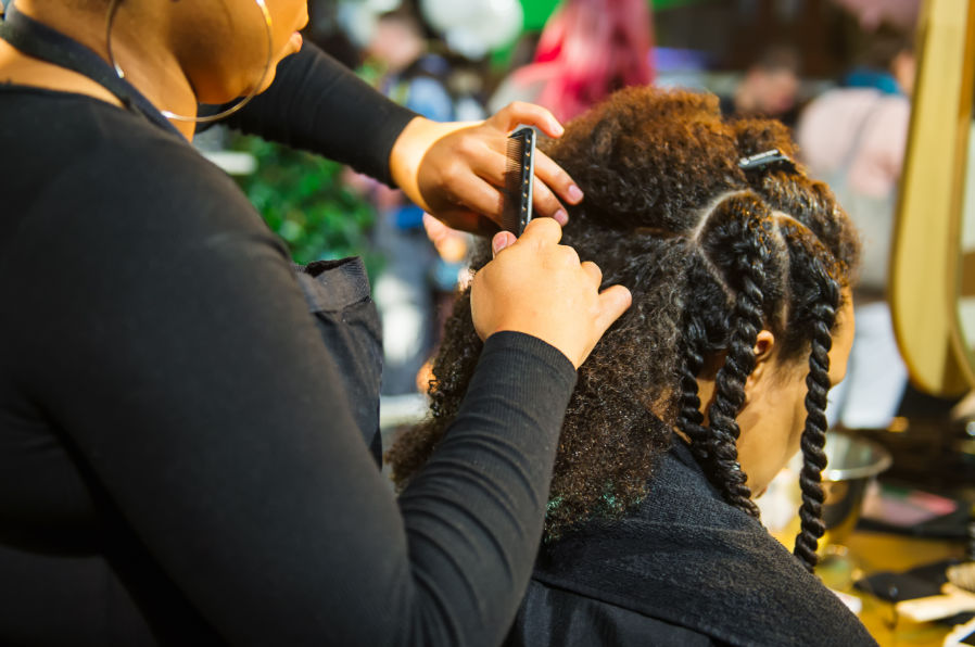 Hair stylist making braids